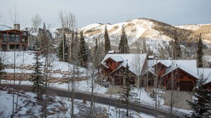 A lodge with multiple wooden cabins, a stone building, and a mountainous backdrop. - Arrowleaf Lodge - Two Bedroom Condo Residence #209 by Deer Valley Resort (Park City)