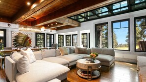 A spacious living room with a large sectional sofa, a round coffee table, and a wooden ceiling. - Stag Lodge At Deer Valley Resort - 4 Bed W/ Spa #7 4 Bedroom Condo (Park City)