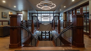 A spacious lobby with a grand staircase, large windows, and modern lighting fixtures. - 202 - Three Bedroom Condo Deluxe Flagstaff by Deer Valley Resort (Park City)