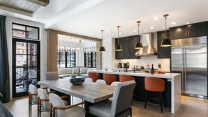 A modern kitchen with a central island, bar stools, and pendant lighting. - 202 - Three Bedroom Condo Deluxe Flagstaff by Deer Valley Resort (Park City)