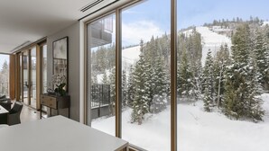 A modern interior with large windows overlooking a snowy landscape. - 1504 Founders Place - Three Bedroom Condo Deluxe by Deer Valley Resort (Park City)