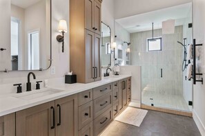 A modern bathroom with a large mirror, dual sinks, and a walk-in shower. - 11981 N Gemini Way Skyridge 5 Bedroom Home With Hot Tub by Deer Valley Resort (Heber City)