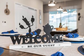 A hotel reception area with a 'WELCOME' sign and a 'BE OUR GUEST' placard. - 3416lw-windsor Island Resort 5 Bedroom Home (Davenport)