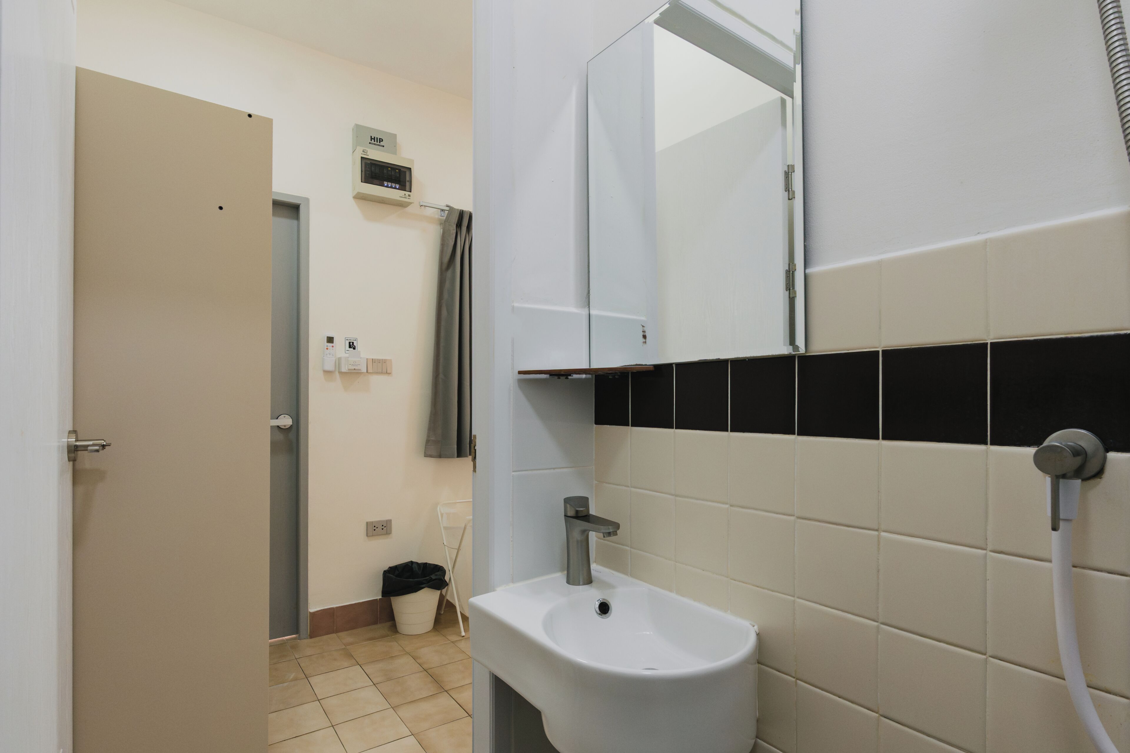 A bathroom with a sink, mirror, and towel rack.