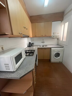 Fridge, microwave, coffee/tea maker, cookware/dishes/utensils