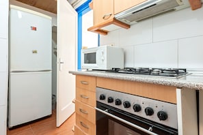 Fridge, microwave, coffee/tea maker, cookware/dishes/utensils