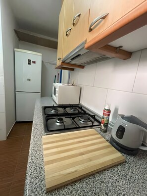 Fridge, microwave, coffee/tea maker, cookware/dishes/utensils