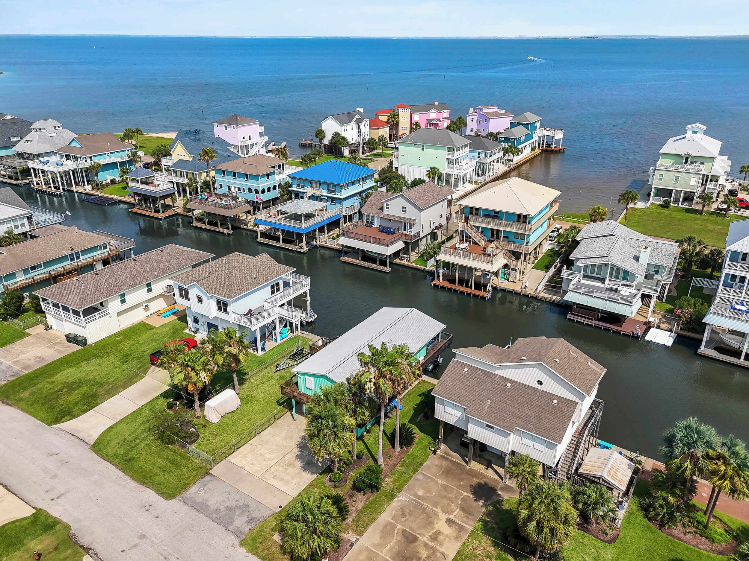 A residential area with houses along a waterway, featuring docks and waterfront views.