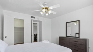 A bedroom with a bed, a dresser, a mirror, and a ceiling fan. - Apt. In college Station TX Mins to major hospitals and A&M U (College Station)