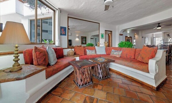 A living room with a sectional sofa, a coffee table, and a lamp. - Ocean View 2Br Condo-balcony-beach-pool - 303 (Puerto Vallarta)