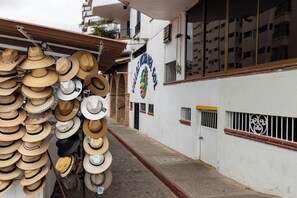 A street with a row of hats hanging on a wall.