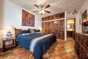 A bedroom with a bed, a ceiling fan, a wooden wardrobe, and a tiled floor. - Ocean View 2Br Condo-balcony-beach-pool - 802 (Puerto Vallarta)