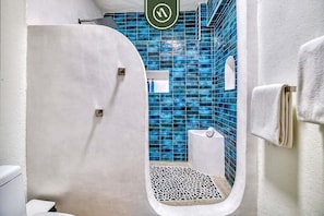 A bathroom with a bathtub, a shower, and a toilet.