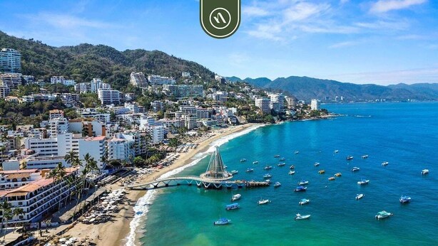 A coastal cityscape with a beach, buildings, and boats. - Elegant Studio in Romantic Zone - Rooftop Pool (Puerto Vallarta)