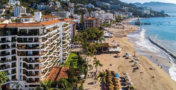 A coastal hotel with multiple balconies, a beach, and a pier. - Ocean View 2Br Condo-balcony-beach-pool - 805 (Puerto Vallarta)