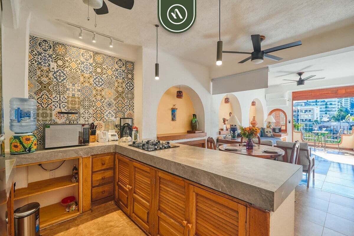 A modern kitchen with a patterned backsplash, wooden cabinets, and a central island.