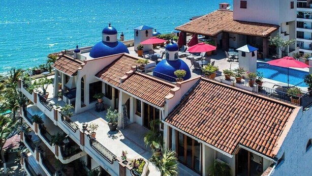 A hotel with multiple blue-domed structures, a swimming pool, and a view of the sea. - Ocean View 1Br Condo-balcony-beach-pool - 606 (Puerto Vallarta)