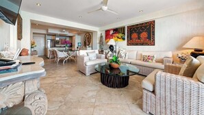 A spacious living area with a dining table, sofas, and a kitchen in the background. - Ocean View 2Br Condo-balcony-beach-pool - 712 (Puerto Vallarta)
