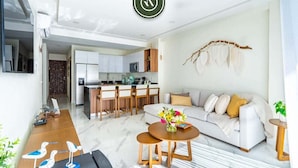 A modern living room with a sofa, coffee table, and decorative items.