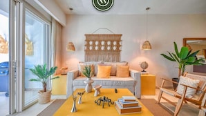 A modern living room with a sofa, a coffee table, and decorative items. - Amazing 2BR Condo in Nuevo Vallarta - Pool - King (Nuevo Nayarit)