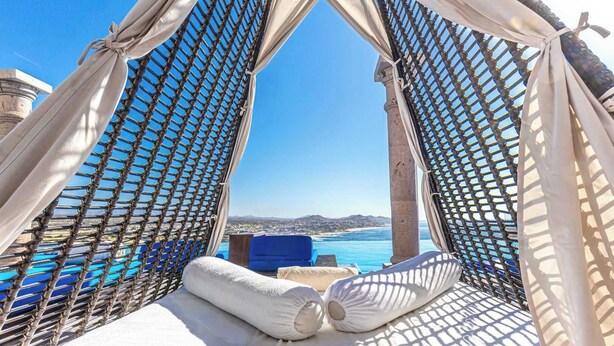 A hammock with a view of the sea and a cityscape. - Two Bdrm House With Ocean View in Cabo (Cabo San Lucas)