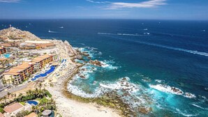 A coastal resort with multiple swimming pools, a rocky shoreline, and a view of the ocean. - Two Bdrm House With Ocean View in Cabo (Cabo San Lucas)