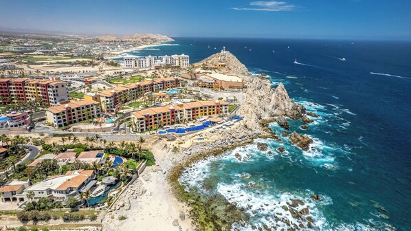 A coastal resort with multiple buildings, a rocky cliff, and a beach. - Two Bdrm House With Ocean View in Cabo (Cabo San Lucas)