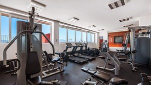 A gym with treadmills, weight machines, and benches. - Equipped 3BR House - Pool - Gym - 5 min to Beach (Nuevo Nayarit)