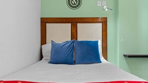 A bed with a wooden headboard, white bedding, and a red floral-patterned throw. - Beautiful 2 BR Condo Amazing Rooftop Pool - Gym (Puerto Vallarta)