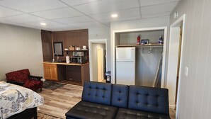 A compact hotel room with a bed, a sofa, a kitchenette, and a bathroom. - Unit 5 The most peaceful and quite area of Schenectady downtown (Schenectady)