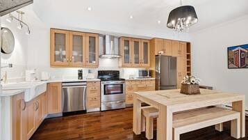 A modern kitchen with wooden cabinets, stainless steel appliances, and a central island.
