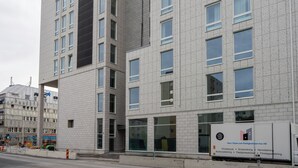 Un edificio de varios pisos con amplios ventanales y una fachada moderna y limpia.