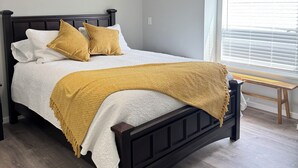 A bedroom with a bed, a ceiling fan, and a window with blinds. - Nancy James
Charming 2-bedroom retreat with a charming porch in Candler (Candler)