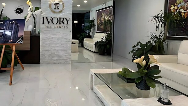 A modern hotel lobby with a reception desk, a seating area, and a decorative ceiling light fixture. - W/ Secure Cabinets, complete appliance + Wifi (Davao City)