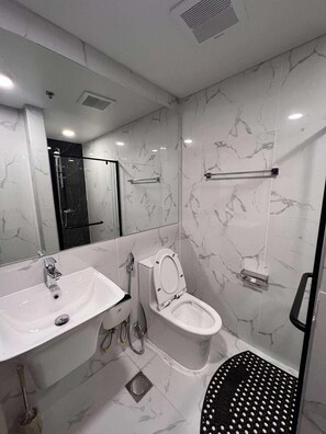Een douche, een haardroger, een bidet, handdoeken