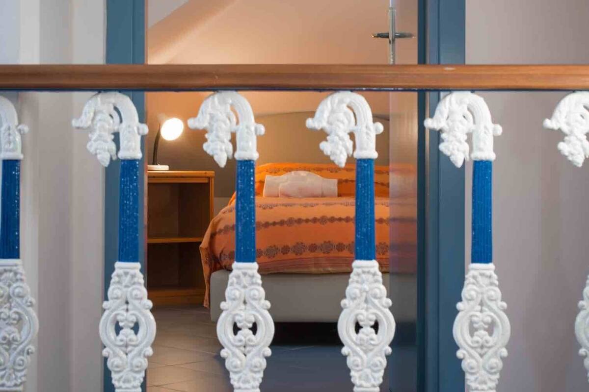 Ein Schlafzimmer mit Bett, Nachttisch und Spiegel.