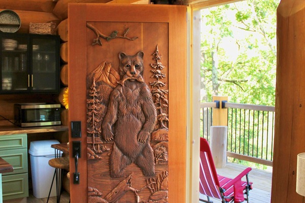 One of the most unique features of this custom Log Home is this hand carved front door by a skilled Canadian Artisan. Each detail was carefully crafted to reflect both beauty and craftsmanship, making it a true piece of art.