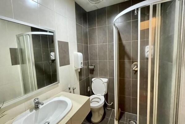 A bathroom with a sink, toilet, and shower. - PLAY at Iris Resort Tanah Rata (Cameron Highlands)