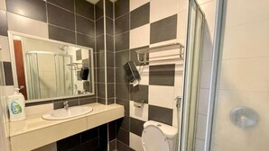A bathroom with a sink, mirror, toilet, and shower. - PLAY at Iris Resort Tanah Rata (Cameron Highlands)