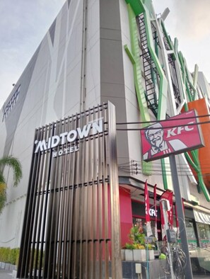 A hotel with a prominent KFC sign and a modern facade.