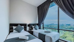 A hotel room with two beds, a large window with curtains, and a city view. - Opus Residences by Wakely Kuala Lumpur (Kuala Lumpur)