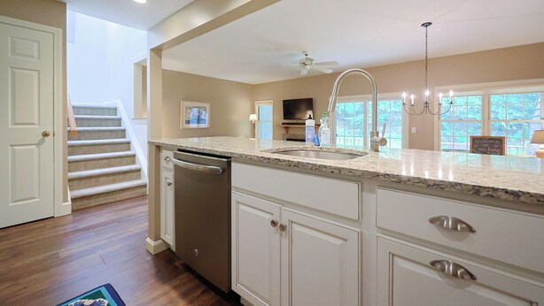 A kitchen with a dishwasher, a sink, and a countertop. There is a staircase leading to another level. - Jiminy Peak Slopeside Getaway • Ski & Adventure (Hancock)