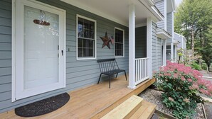 A house with a porch, a bench, and a star decoration. - Jiminy Peak Slopeside Getaway • Ski & Adventure (Hancock)