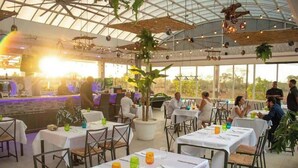 A restaurant with tables set for dining, a bar area, and large windows allowing natural light. - Private Pool • Luxury • Casa Linda (Sosúa)