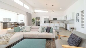 A modern living room with a sofa, a coffee table, and a dining area. - Private Pool • Luxury • Casa Linda (Sosúa)