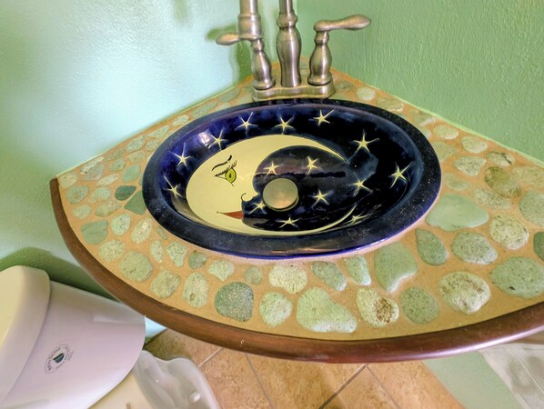 A bathroom sink with a decorative basin and a faucet. - Serenity Estates (St Croix)