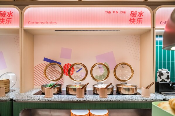 A buffet area with multiple food stations, including a section labeled "Carbohydrates." - Orange Hotel Guangzhou Tianhe Sports Center (Guangzhou)