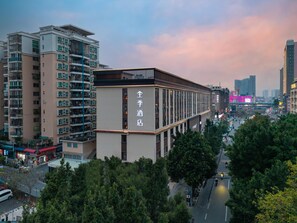 A hotel with a modern facade, multiple floors, and a prominent sign indicating it is a hotel.