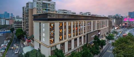 A modern hotel with multiple floors and a prominent entrance.