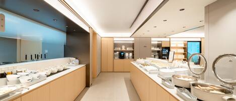 A modern kitchen with wooden cabinets, a central island with a sink, and various kitchen appliances.